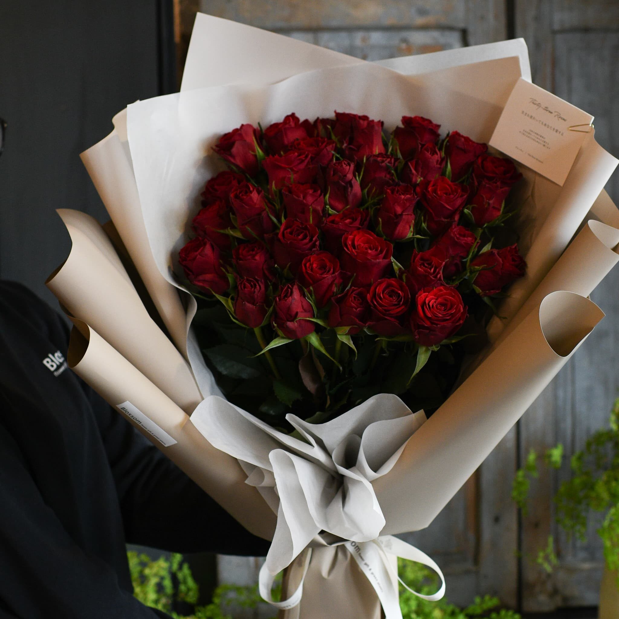 白いラッピングで仕上げたプロポーズ用の赤薔薇の花束